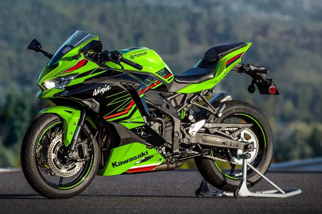 Zielony motocykl Kawasaki Ninja zx4rr na stojaku, gotowy do jazdy po krętej drodze.