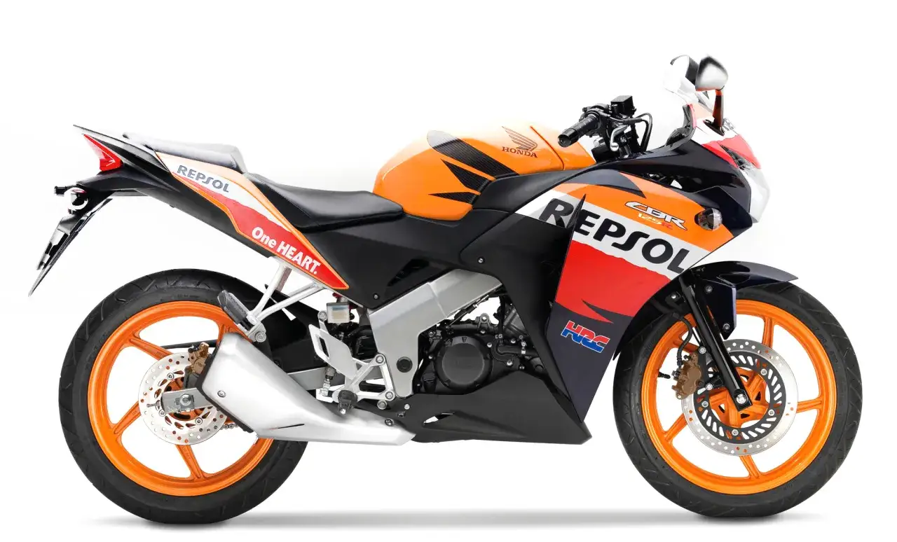 Pomarańczowo-czarny motocykl Honda CBR 125R Repsol. Sprawdź honda cbr 125 dane techniczne.